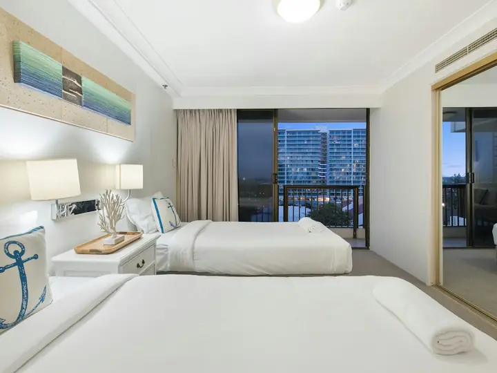 Freshly made bed with crisp white linen