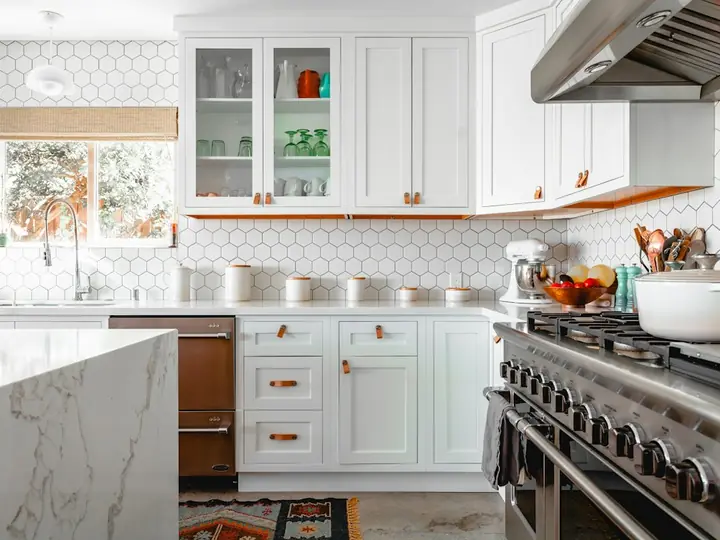 Spotless bright kitchen with white cabinets